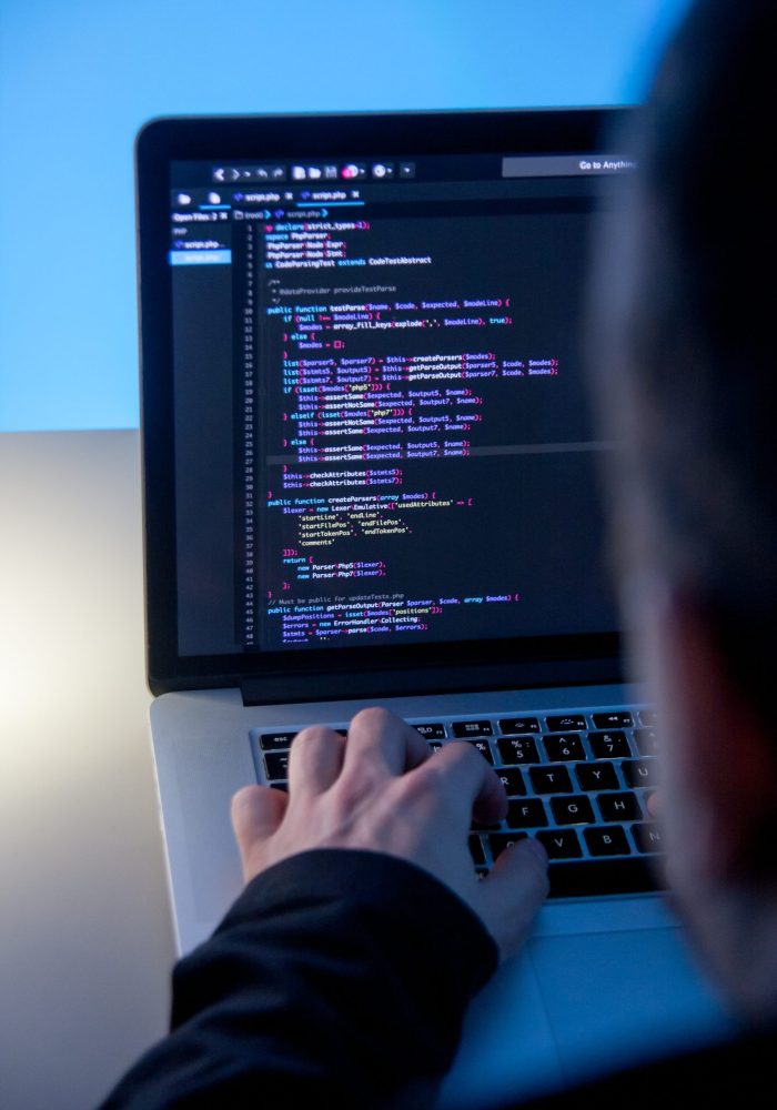 Web Coder working on laptop computer in office