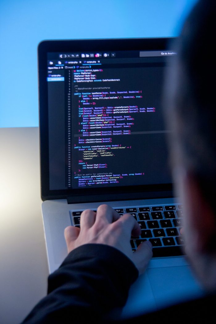 Web Coder working on laptop computer in office